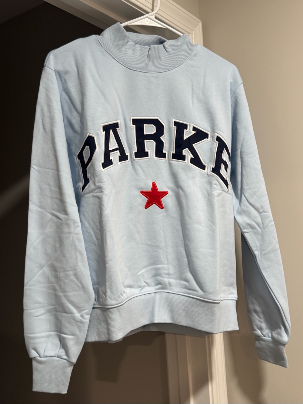 Parker Light Blue Sweatshirt with Navy Lettering and Red Star